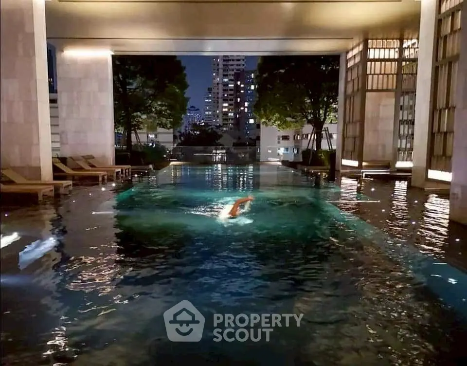 Luxurious indoor pool with city view, perfect for relaxation and leisure in a high-end residential complex.