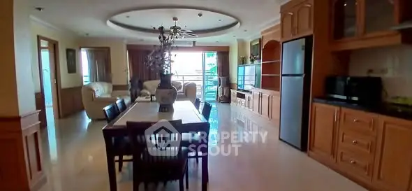 Spacious open-plan living and dining area with modern kitchen and natural light.