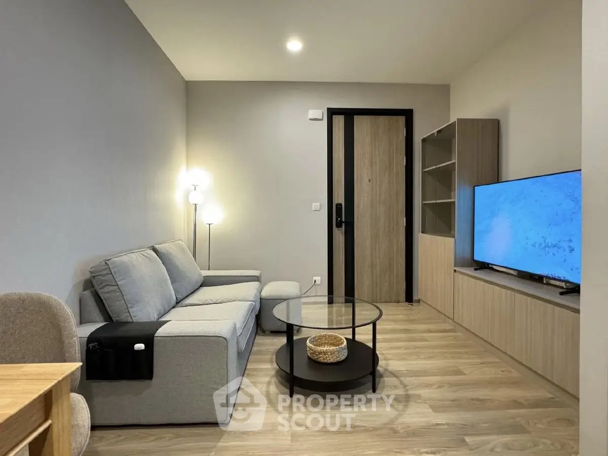 Modern living room with sleek furniture and flat-screen TV, perfect for relaxation and entertainment.
