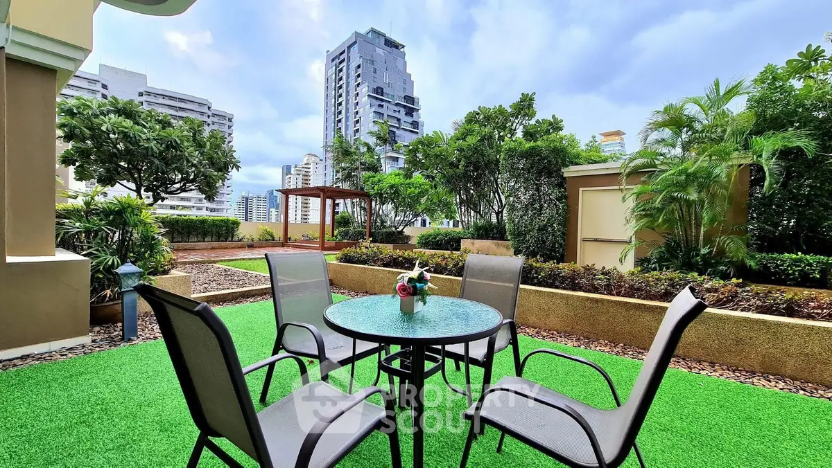 Luxurious garden patio with modern furniture and stunning cityscape view, perfect for outdoor relaxation.