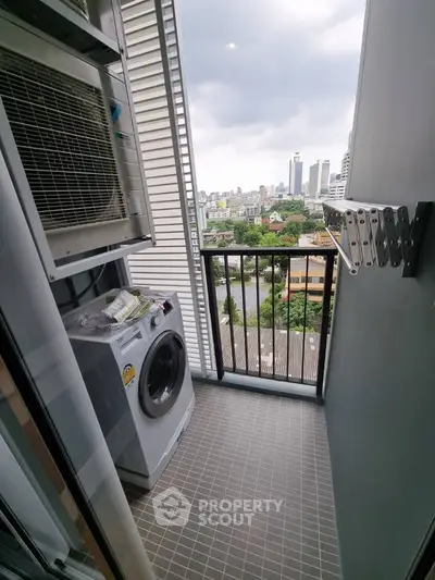 Compact balcony with washing machine and city view, perfect for urban living convenience.