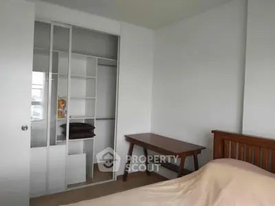Cozy bedroom with built-in closet and wooden furniture