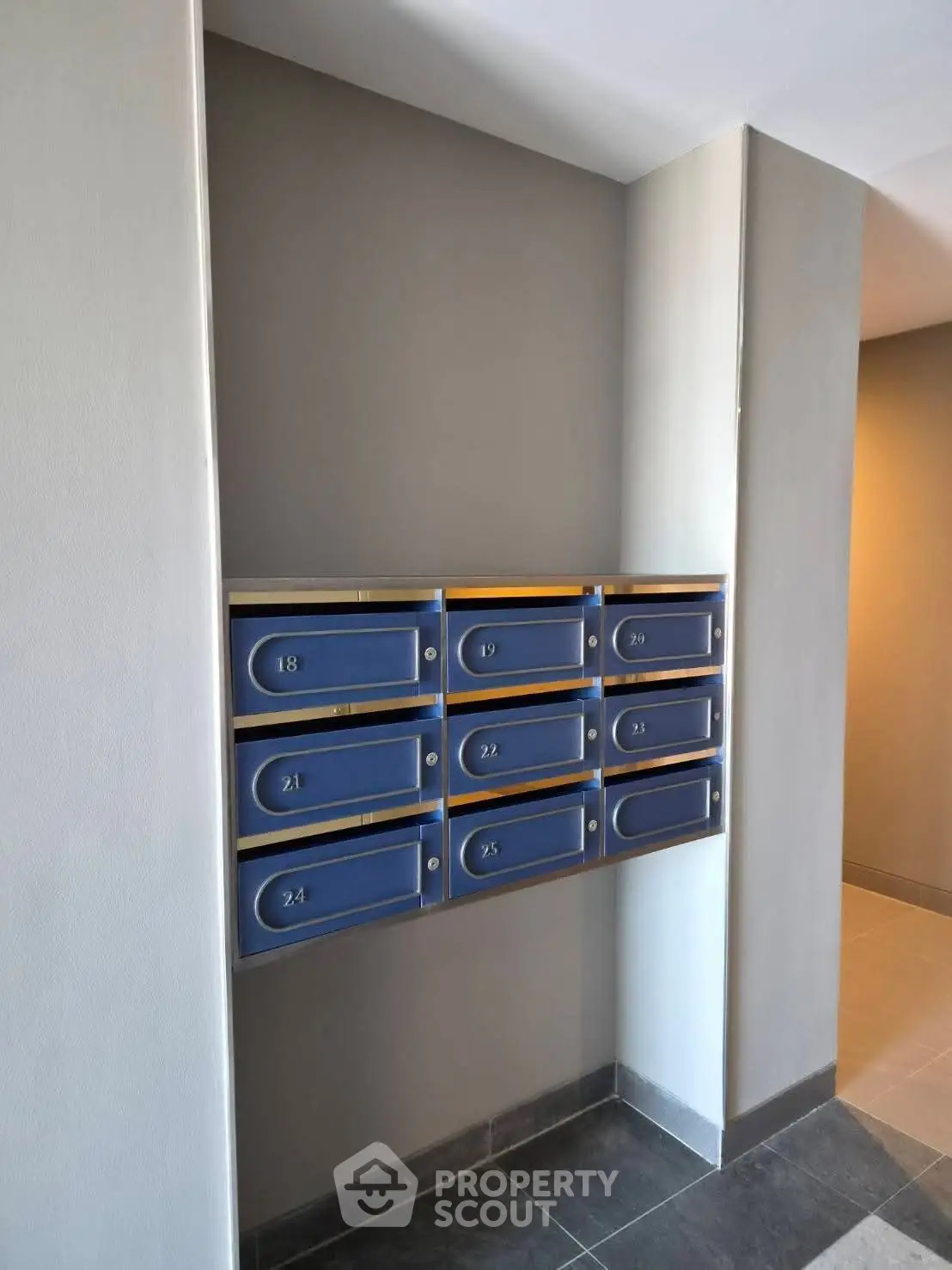 Modern apartment building mailboxes in a sleek hallway with contemporary design.