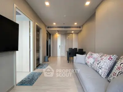 Modern living room with stylish decor and dining area in open layout apartment.