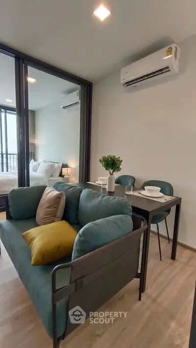 Modern living room with cozy seating and dining area in a stylish apartment.