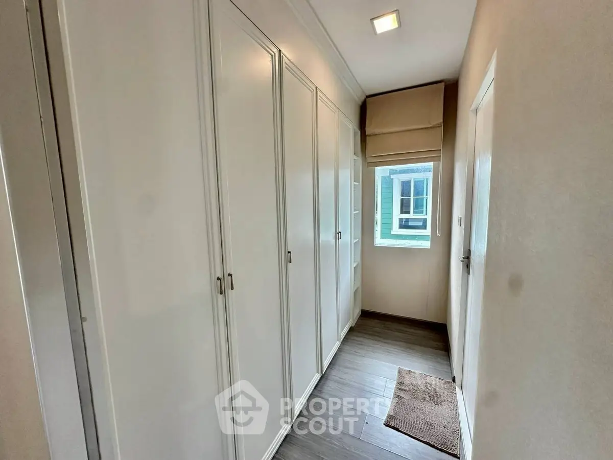 Spacious hallway with built-in closets and natural light