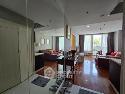 Spacious living room with modern decor and large windows offering natural light.