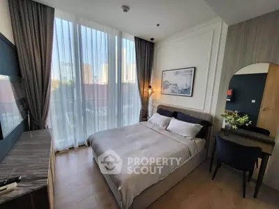 Luxurious bedroom with floor-to-ceiling windows and elegant decor in modern apartment.