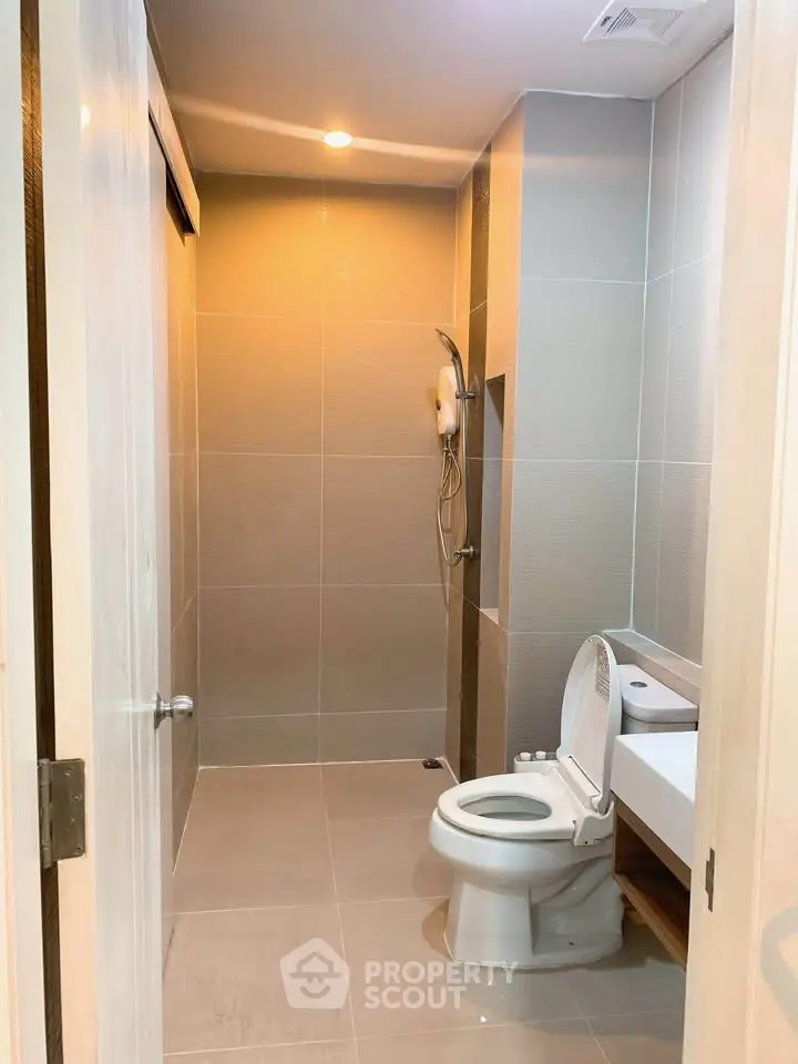Modern bathroom with sleek design and shower area in contemporary apartment.