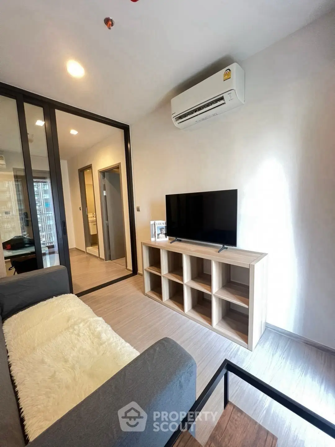 Modern living room with sleek furniture and air conditioning in a stylish apartment.
