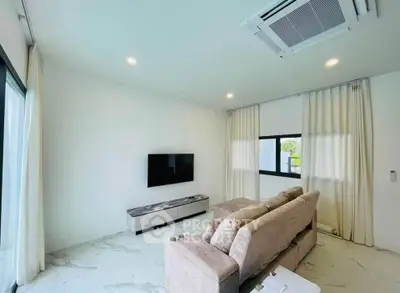 Modern living room with sleek design, featuring a wall-mounted TV, plush sofa, and elegant marble flooring.