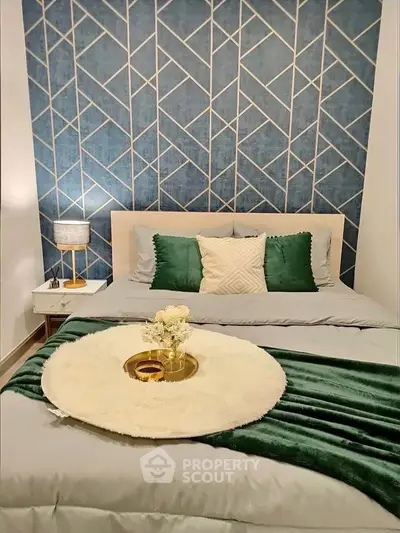 Stylish bedroom with geometric accent wall and elegant decor