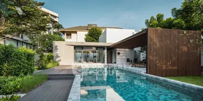 Luxurious modern home with stunning pool and lush garden, perfect for relaxation and entertainment.
