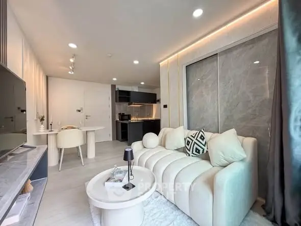 Modern living room with stylish sofa and open kitchen layout in a chic apartment.