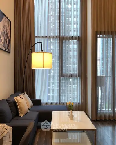 Modern living room with floor-to-ceiling windows and stylish decor