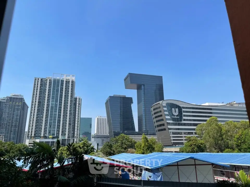 Stunning cityscape view featuring modern architecture and lush greenery, perfect for urban living.