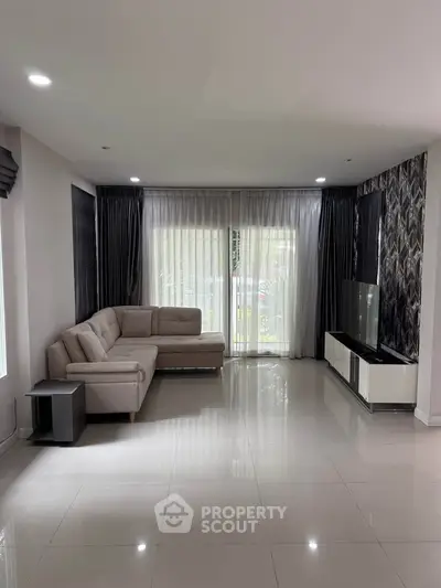 Spacious modern living room with elegant decor and large windows