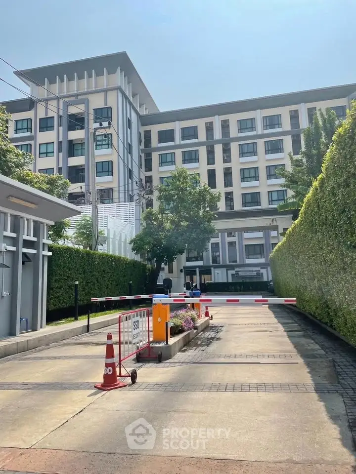 Modern residential building with lush greenery and secure entrance
