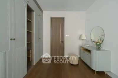 Elegant bedroom with built-in wardrobe and stylish vanity in modern apartment