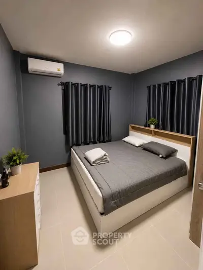 Modern bedroom with sleek design, featuring a comfortable bed and stylish decor.