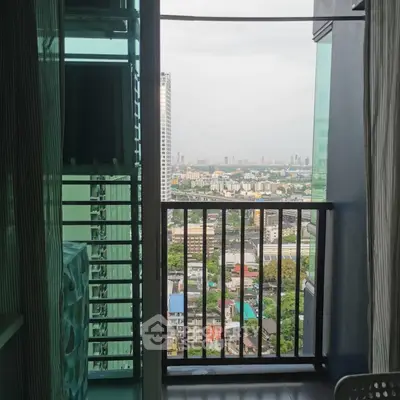 Stunning city view from a modern apartment balcony with sleek railing.