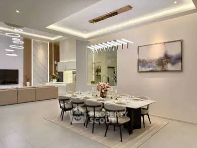 Luxurious open-plan living and dining area with modern lighting and elegant decor.