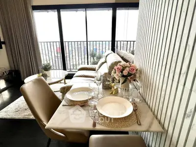 Luxurious living room with elegant dining setup and stunning city view from high-rise apartment.