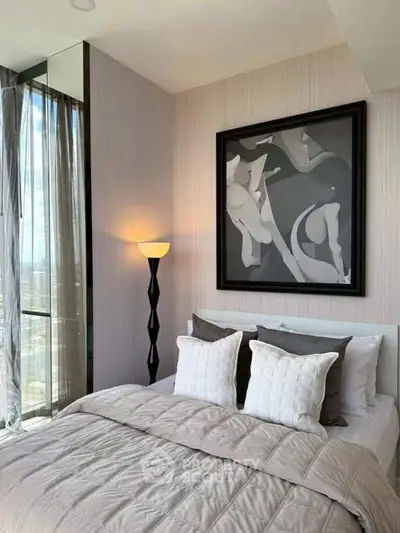 Luxurious bedroom with modern decor and floor-to-ceiling windows offering stunning views.