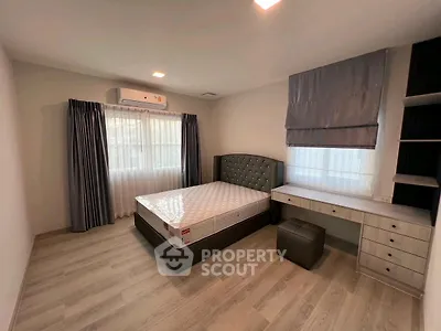 Spacious bedroom with modern decor and ample natural light