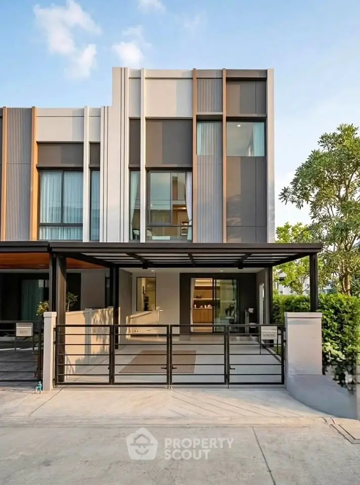 Modern townhouse exterior with sleek design and gated entrance in a serene neighborhood.