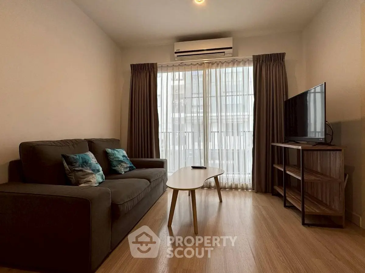 Modern living room with cozy sofa, stylish coffee table, and large TV, perfect for relaxation.