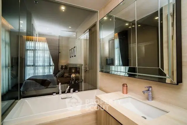 Luxurious bathroom with modern fixtures and large mirror in upscale apartment.