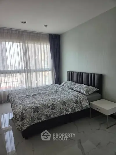 Modern bedroom with large window and stylish decor