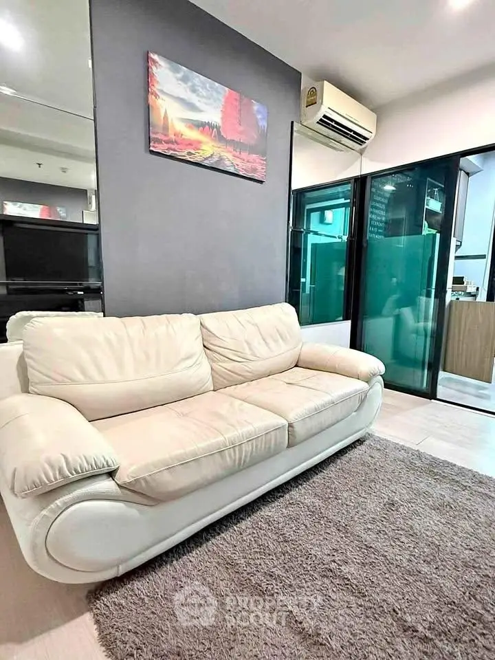Modern living room with stylish sofa and air conditioning in a contemporary apartment.