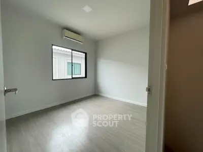 Spacious unfurnished room with large window and air conditioning unit.