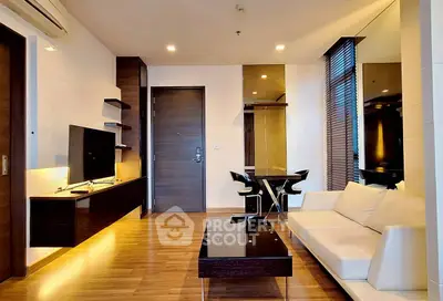 Modern living room with sleek furniture and wooden flooring in a stylish apartment.