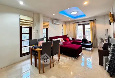 Spacious living room with modern furniture and natural light, perfect for family gatherings.