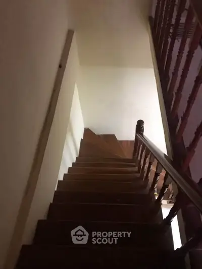 Elegant wooden staircase with classic railing in a cozy home interior