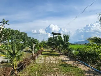 Scenic rural landscape with lush greenery and clear blue sky, perfect for tranquil living or farming.