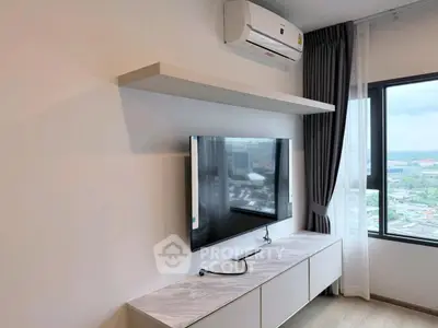 Modern living room with wall-mounted TV and air conditioning, offering a city view.