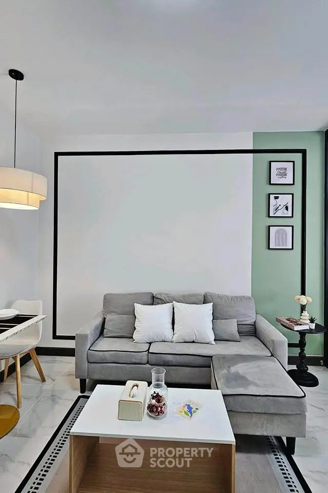 Modern living room with gray sofa, stylish decor, and elegant lighting