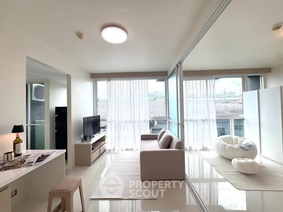Bright and spacious living room with modern decor and large windows
