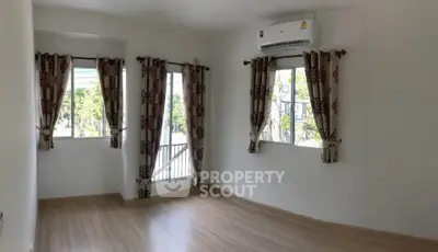Bright and airy room with large windows and elegant curtains, perfect for a cozy living space.