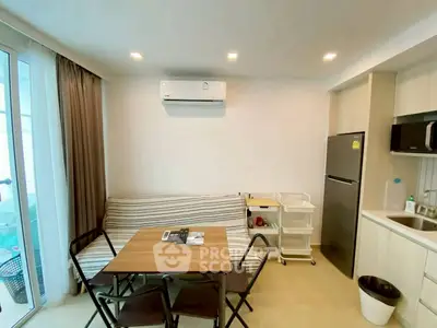 Cozy modern kitchen with dining area, featuring sleek appliances and ample natural light.