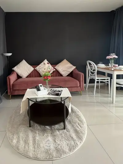 Stylish living room with modern decor, featuring a plush sofa, elegant dining set, and chic coffee table.