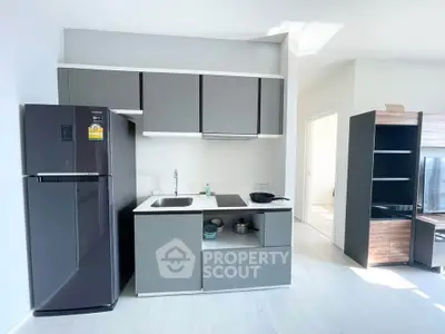 Modern kitchen with sleek cabinetry and appliances in a bright apartment