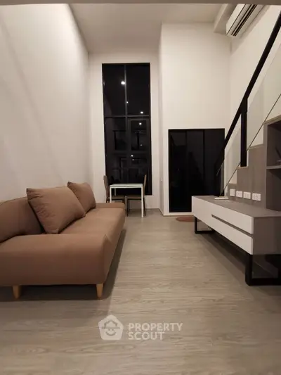 Modern living room with high ceiling and stylish furniture