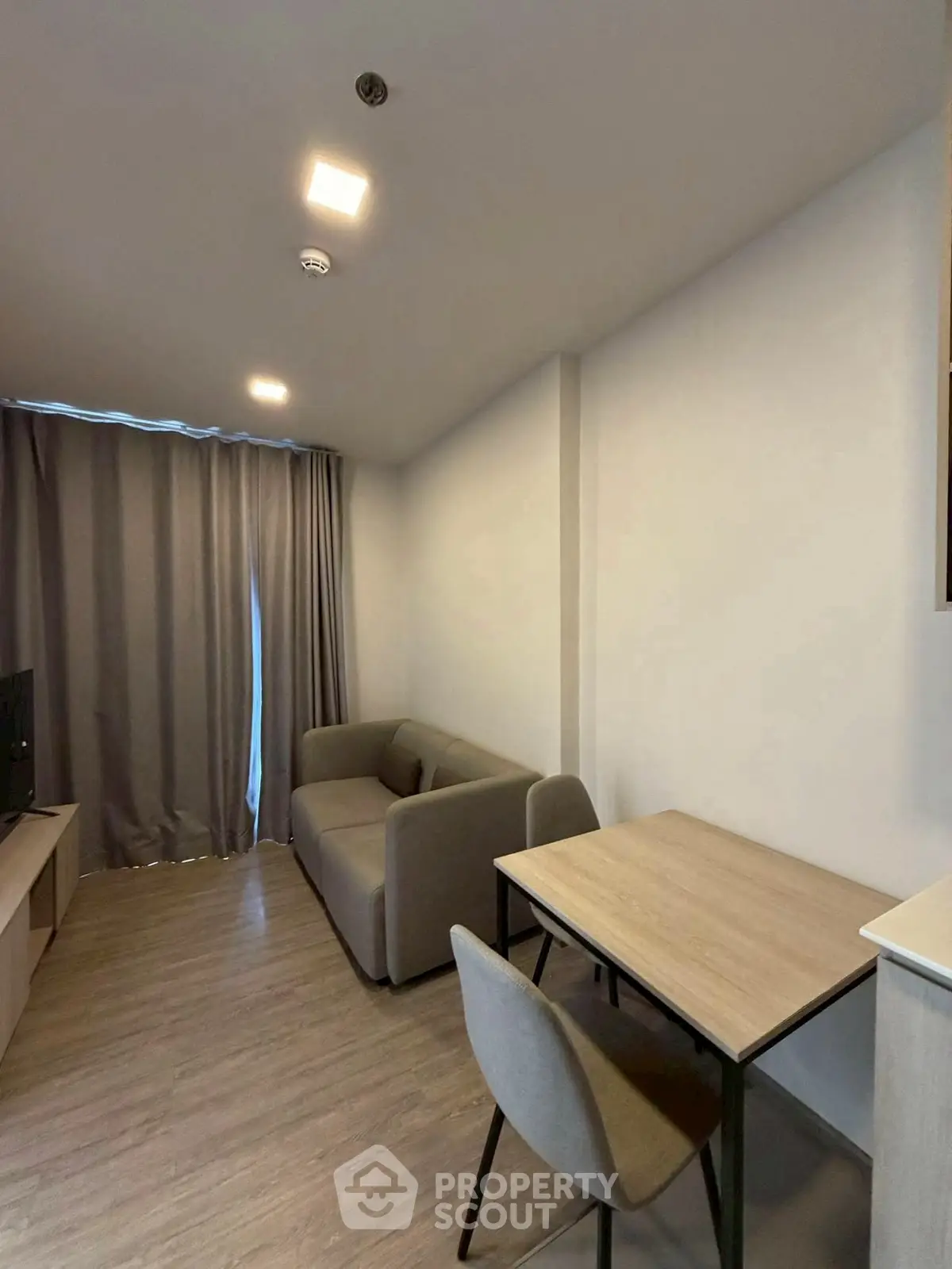 Modern living room with cozy sofa and dining table in a stylish apartment.