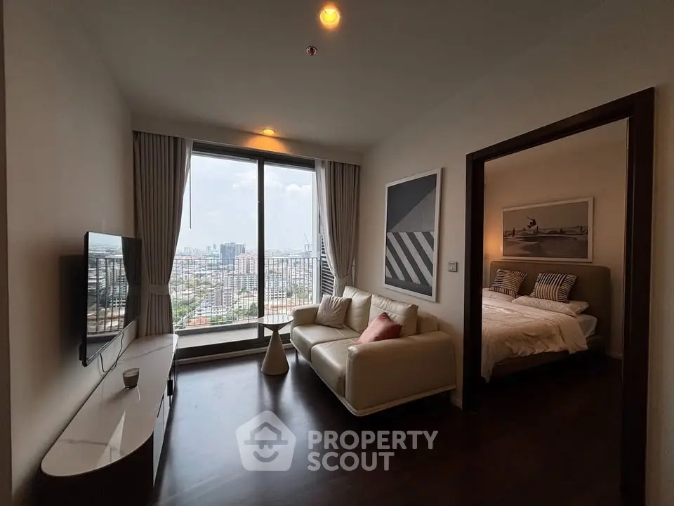 Modern living room with city view and adjacent bedroom in high-rise apartment.