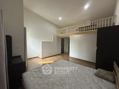 Spacious loft bedroom with modern design and wooden flooring